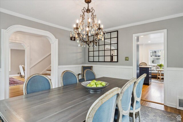 1704 E Herbert Ave, Salt Lake City, UT 84108 - dining room featuring arched walkways, stairs, crown molding, and wood finished floors