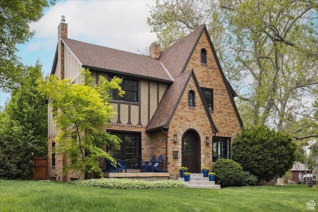 1704 E Herbert Ave, Salt Lake City, UT 84108 - rear view of property with a chimney, roof with shingles, and a lawn