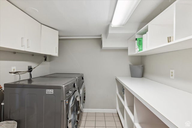1704 E Herbert Ave, Salt Lake City, UT 84108 - laundry area featuring baseboards, independent washer and dryer, light tile patterned floors, and cabinet space