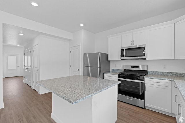 kitchen with light wood-style floors, stainless steel appliances, white cabinets, and recessed lighting