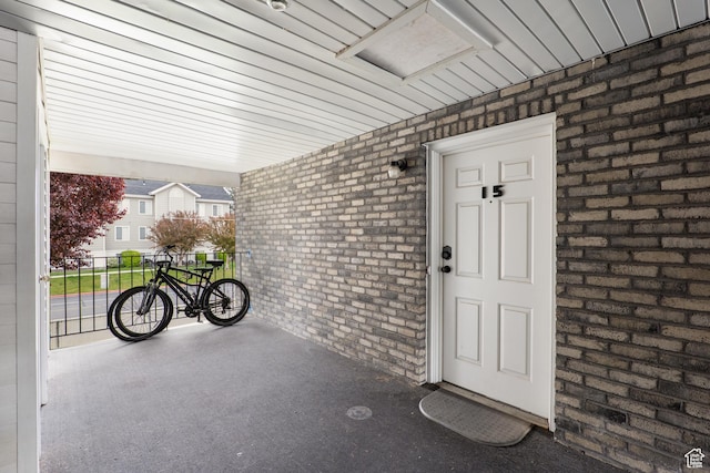 doorway to property with brick siding