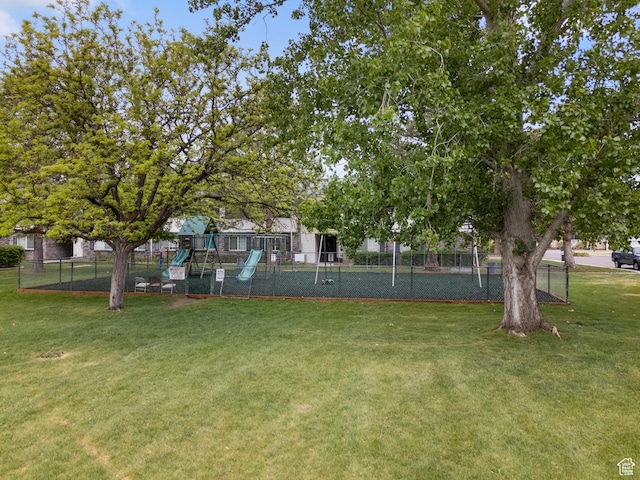 view of yard with playground community and fence