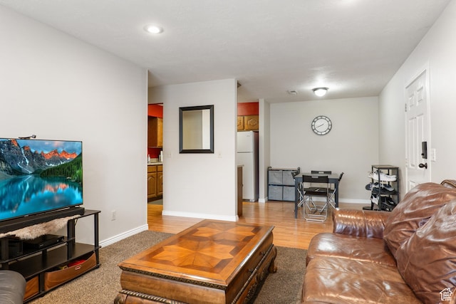 living area with baseboards, recessed lighting, and wood finished floors