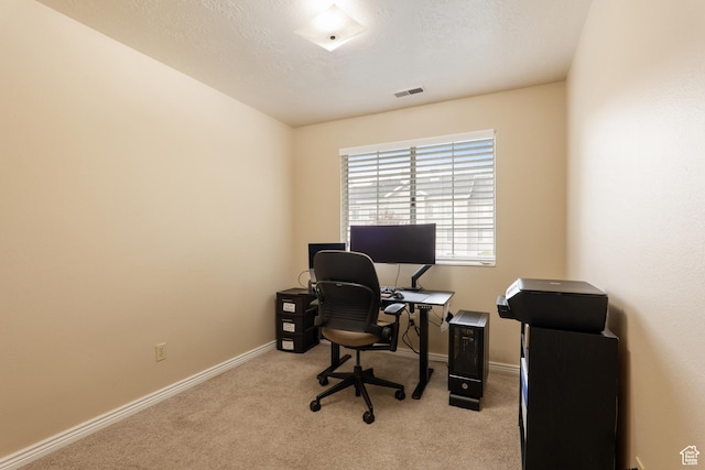 office space with light carpet, baseboards, and visible vents