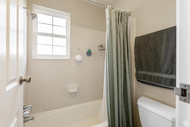 bathroom featuring toilet and shower / bathtub combination with curtain
