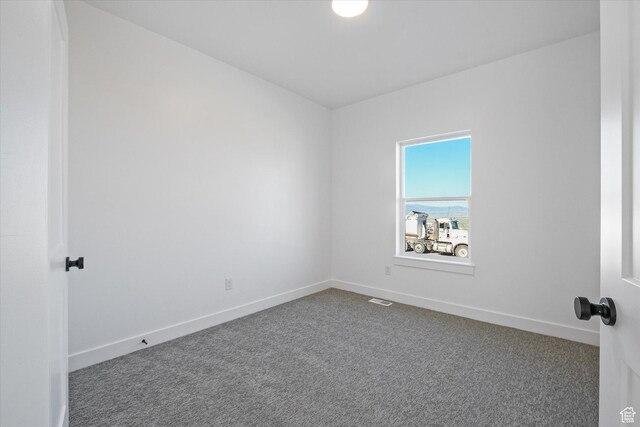 108 N 900 E, Hyde Park, UT 84318 - spare room featuring baseboards, dark colored carpet, and visible vents