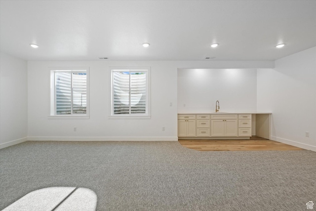 108 N 900 E, Hyde Park, UT 84318 - unfurnished living room featuring baseboards, light carpet, recessed lighting, and a sink