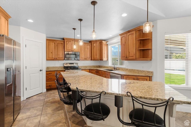 635 N 460 E, Ephraim, UT 84627 - kitchen featuring a center island, a sink, a kitchen breakfast bar, appliances with stainless steel finishes, and light stone counters