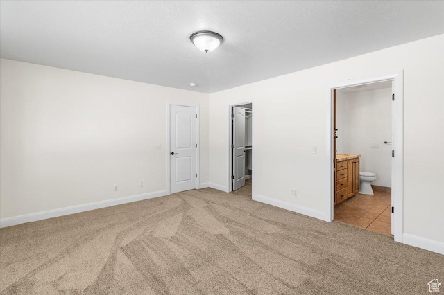 635 N 460 E, Ephraim, UT 84627 - unfurnished bedroom with baseboards, light carpet, connected bathroom, and a spacious closet