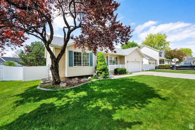 view of front of house featuring a front yard, fence, a garage, and driveway