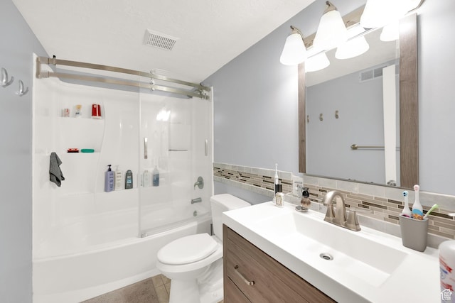bathroom featuring toilet, enclosed tub / shower combo, visible vents, tile patterned flooring, and vanity