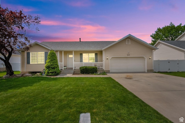 ranch-style house featuring fence, covered porch, an attached garage, concrete driveway, and a front lawn