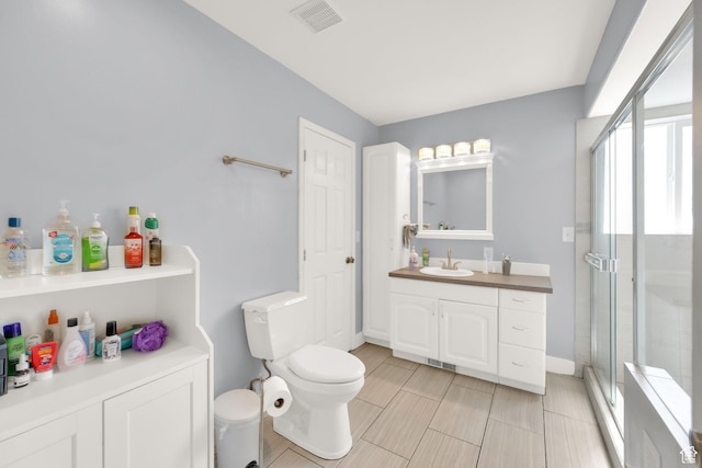 full bathroom featuring vanity, toilet, visible vents, and a stall shower
