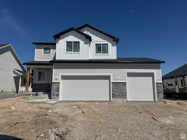 2831 S Allison Way Unit 110, Syracuse, UT 84075 - view of front of house featuring stone siding, a garage, and board and batten siding