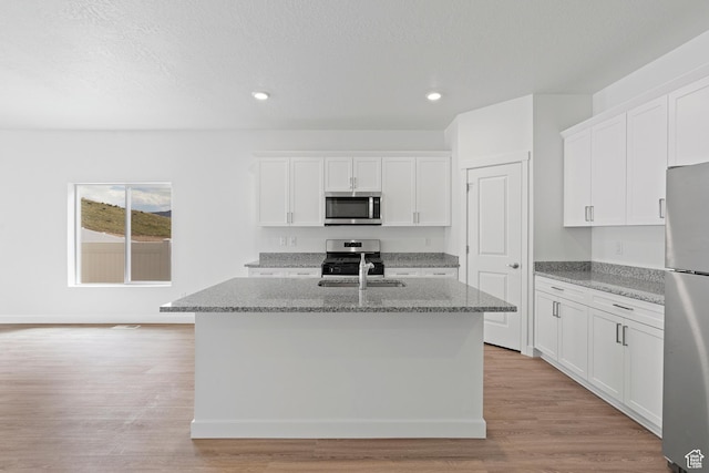 kitchen featuring white cabinets, a kitchen island with sink, recessed lighting, and appliances with stainless steel finishes