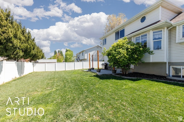 view of yard featuring fence and a patio
