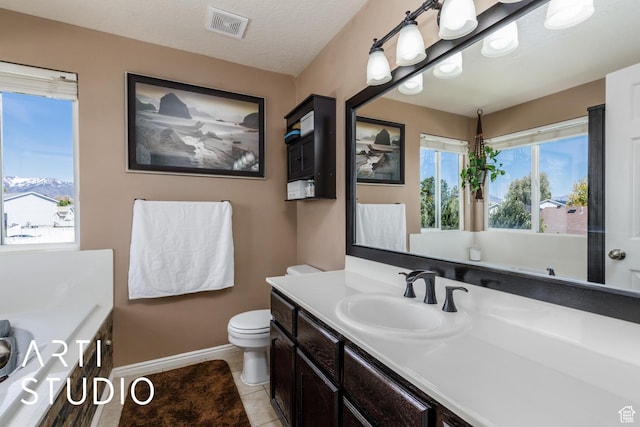 bathroom featuring toilet, vanity, visible vents, tile patterned flooring, and baseboards