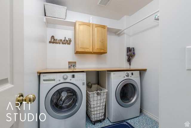 laundry area featuring washing machine and clothes dryer, cabinet space, baseboards, and visible vents