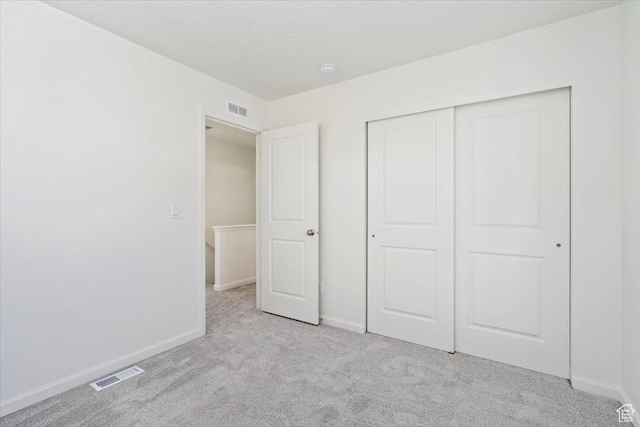 353 N Colonnade Rd Unit 1007, Saratoga Springs, UT 84045 - unfurnished bedroom with baseboards, visible vents, and light colored carpet