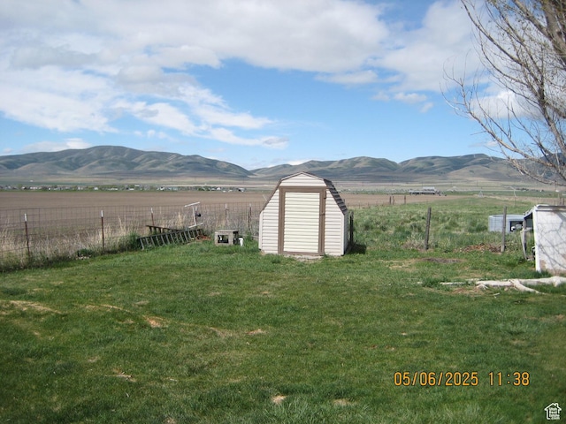 18235 N 4400 W, Fielding, UT 84311 - view of yard featuring a mountain view, a rural view, fence, and a shed