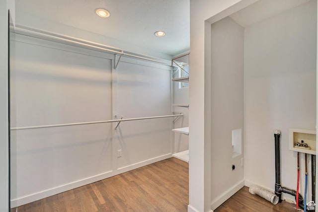 walk in closet featuring wood finished floors