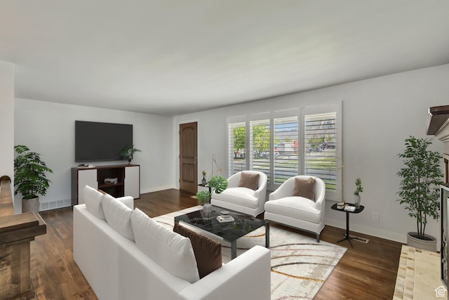 living area featuring baseboards and wood finished floors