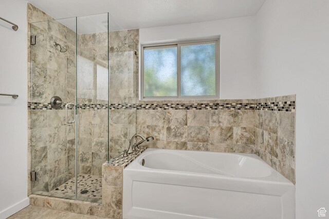 full bath featuring a bath and a shower stall