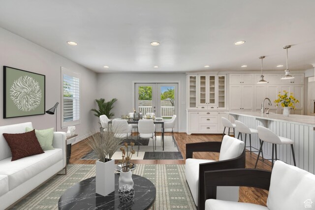 living room with wood finished floors, a healthy amount of sunlight, and recessed lighting