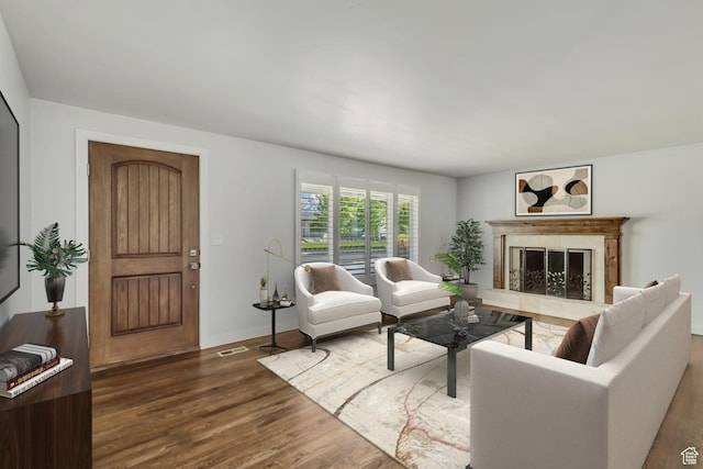 living area with a high end fireplace, baseboards, dark wood-style floors, and visible vents