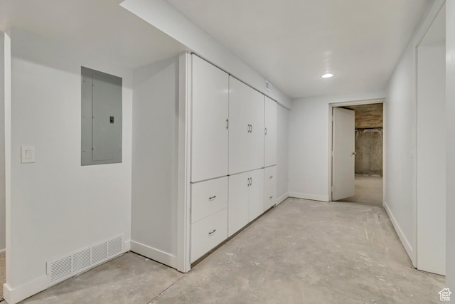 corridor with electric panel, visible vents, recessed lighting, baseboards, and concrete floors