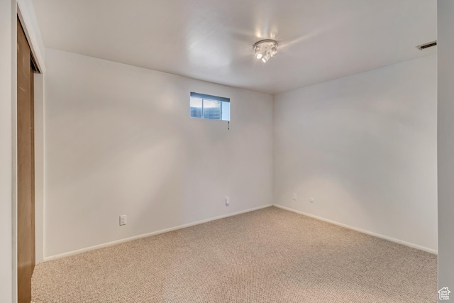 below grade area featuring baseboards, visible vents, and carpet