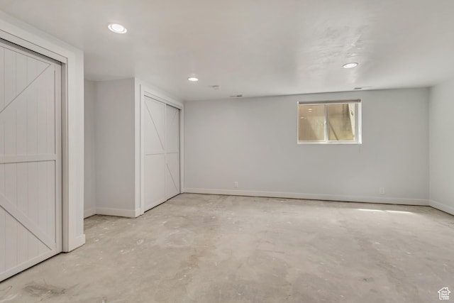 basement featuring baseboards and recessed lighting