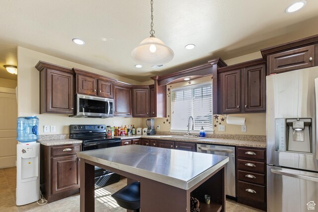 5140 S 3500 W, Roy, UT 84067 - kitchen with a sink, stainless steel appliances, pendant lighting, dark brown cabinetry, and light countertops
