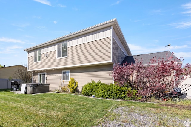 5140 S 3500 W, Roy, UT 84067 - back of property with a hot tub, a lawn, and central AC