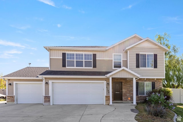5140 S 3500 W, Roy, UT 84067 - view of front of property with driveway, fence, an attached garage, a shingled roof, and stone siding