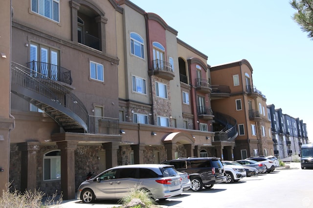 view of building exterior featuring uncovered parking