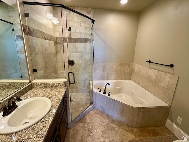 full bathroom featuring a tub with jets, vanity, recessed lighting, a stall shower, and baseboards