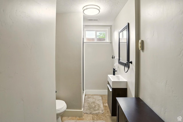 569 N 700 E, Mapleton, UT 84664 - bathroom featuring a textured ceiling, toilet, baseboards, visible vents, and vanity