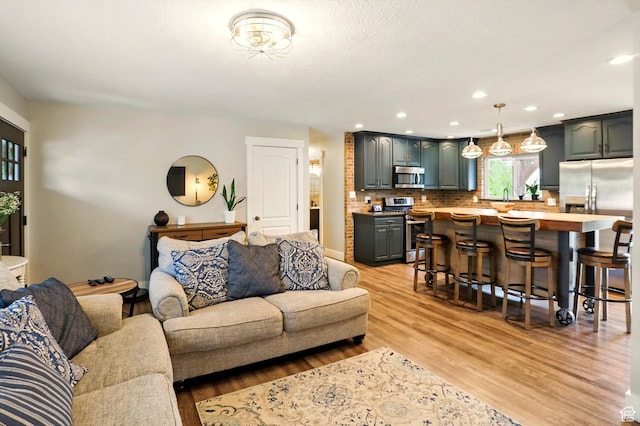 569 N 700 E, Mapleton, UT 84664 - living room featuring light wood finished floors and recessed lighting