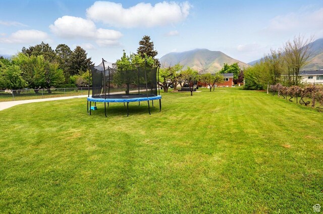 569 N 700 E, Mapleton, UT 84664 - view of yard featuring a trampoline, a mountain view, and fence