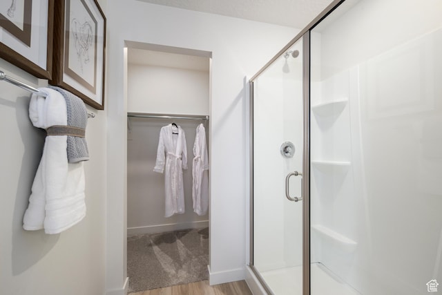 2522 N Wildwood Ln E Unit 240, Heber City, UT 84032 - full bathroom with a walk in closet, a shower stall, and wood finished floors