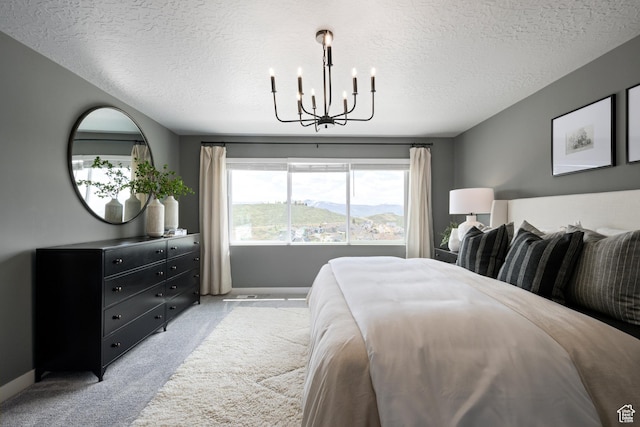 2522 N Wildwood Ln E Unit 240, Heber City, UT 84032 - bedroom featuring light carpet, a textured ceiling, and a chandelier