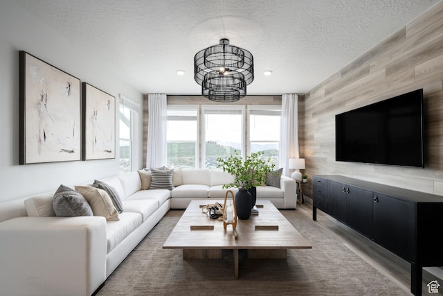 2522 N Wildwood Ln E Unit 240, Heber City, UT 84032 - living room featuring a textured ceiling, light wood-style flooring, and wooden walls