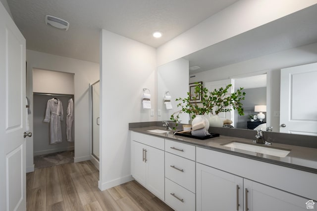 2522 N Wildwood Ln E Unit 240, Heber City, UT 84032 - full bath with double vanity, wood finished floors, a stall shower, ensuite bath, and a textured ceiling