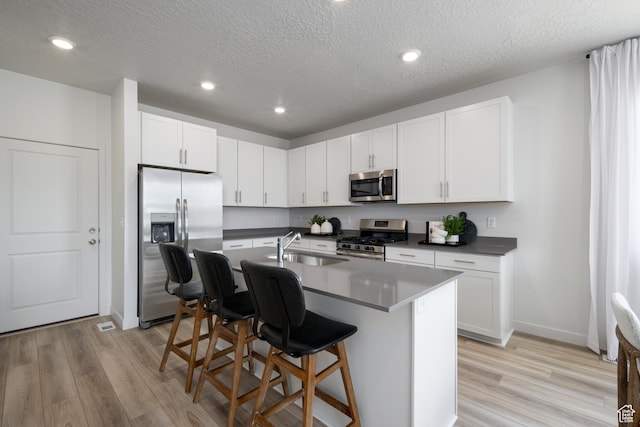 2522 N Wildwood Ln E Unit 240, Heber City, UT 84032 - kitchen featuring stainless steel appliances, light wood-type flooring, a breakfast bar area, a center island with sink, and recessed lighting