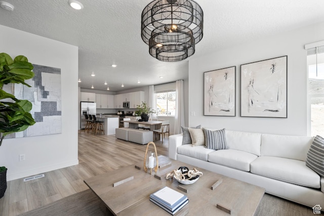 2522 N Wildwood Ln E Unit 240, Heber City, UT 84032 - living area with light wood finished floors, recessed lighting, a chandelier, and a textured ceiling