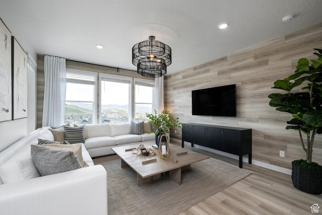 2522 N Wildwood Ln E Unit 240, Heber City, UT 84032 - living room with wood walls, a chandelier, recessed lighting, a textured ceiling, and wood finished floors