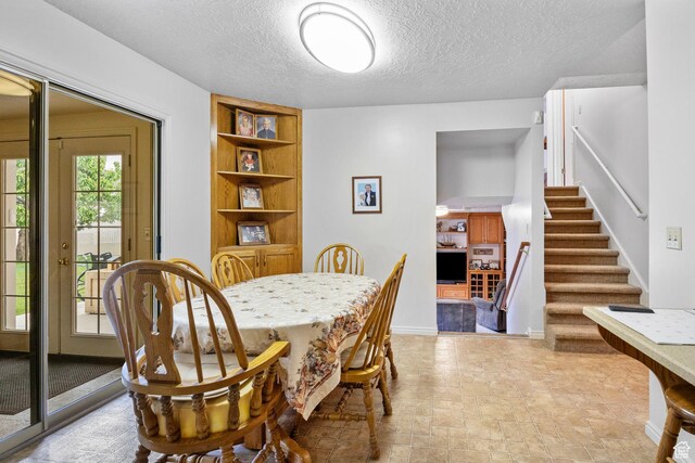 235 W 1000 N, Bountiful, UT 84010 - dining space with a textured ceiling, stairway, and baseboards