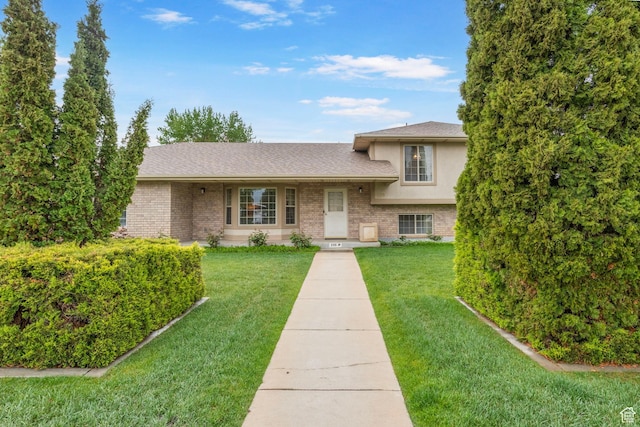 235 W 1000 N, Bountiful, UT 84010 - split level home with a shingled roof, brick siding, and a front yard