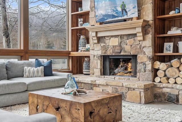 living room with a fireplace and built in features